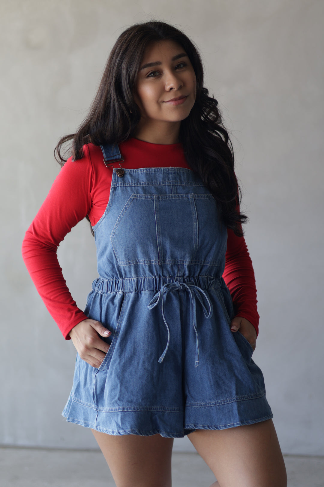 red top with denim overalls