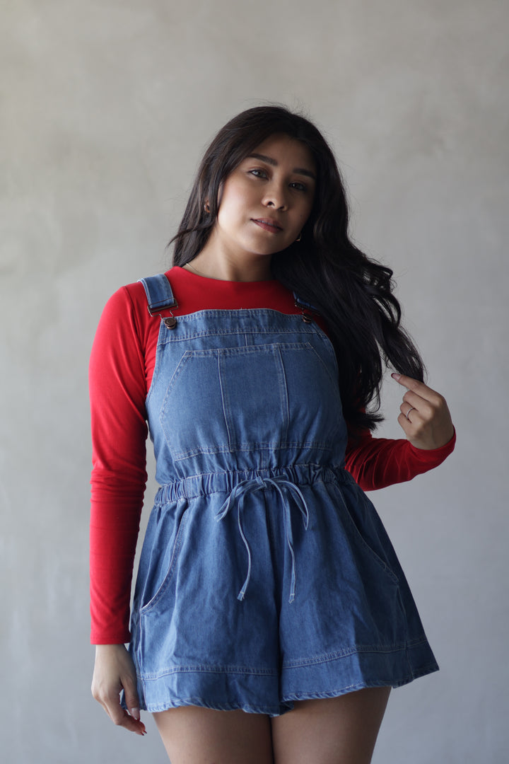 red long sleeve top paired with flowy shorts denim overalls 